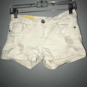 Lightly distressed white denim shorts